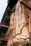 Maijishan Shiku (Maiji Shan Grottoes) are one of China’s four most important Buddhist temple groups (the others being Datong, Luoyang, and the Mogao Caves at Dunhuang).<br/><br/>

Starting from the Northern Wei (386-535) and Northern Zhou (557-81) Dynasties, Buddhists cut caves into the sides of a red outcrop rising from the surrounding foliage-covered hills. Figures of the Buddha, of bodhisattvas and disciples were carved in harder rock brought from elsewhere, and installed in the caves.<br/><br/>

At their height, the Maijishan caves are believed to have numbered almost 800, but they suffered serious damage during an earthquake in 734. This event, combined with the exigencies of time, has reduced the number of extant caves to 194.<br/><br/>

The existing rock cut architecture contains over 7,200 Buddhist sculptures and over 1,000 square meters of murals.<br/><br/>

Maiji Shan translates literally as 'Wheatstack Mountain'.