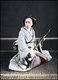 Geisha, Geiko or Geigi are traditional, female Japanese entertainers whose skills include performing various Japanese arts such as classical music and dance.<br/><br/>

The shamisen or samisen, literally 'three flavor strings'), also called sangen (literally 'three strings') is a three-stringed musical instrument played with a plectrum called a bach.