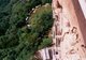 China: View over a standing Buddha down to the garden area, Maiji Shan Grottoes, Tianshui, Gansu Province